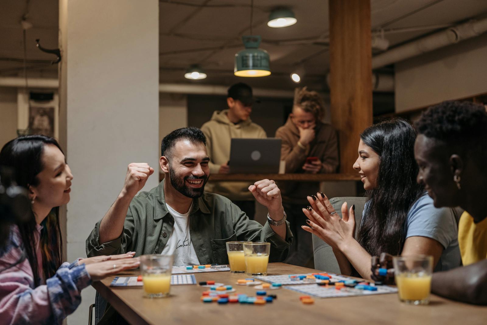 A group of friends playing a board game indoors, enjoying fun and laughter.